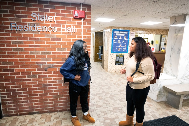 Two students talking with one another