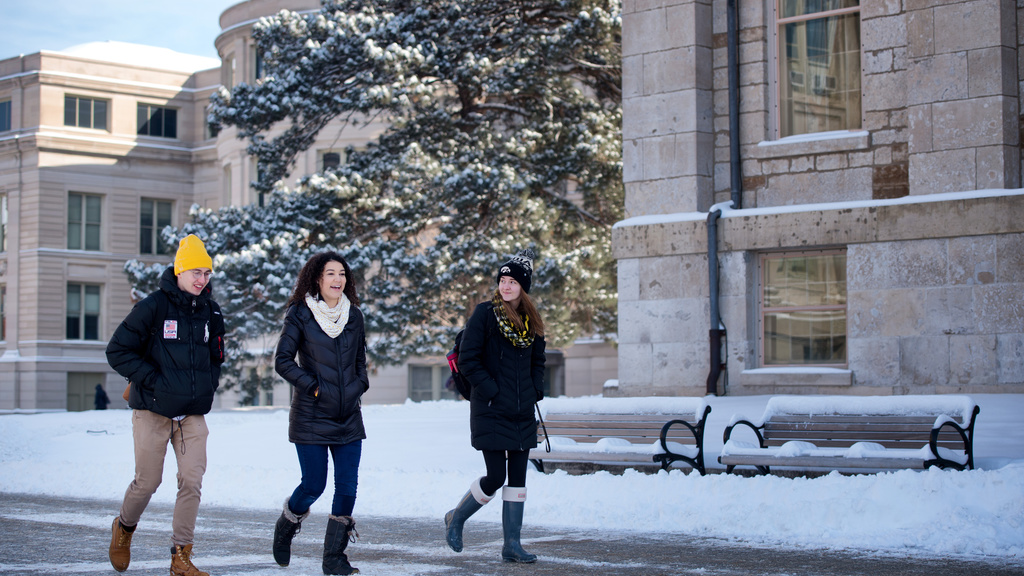 Three students walking in the snow