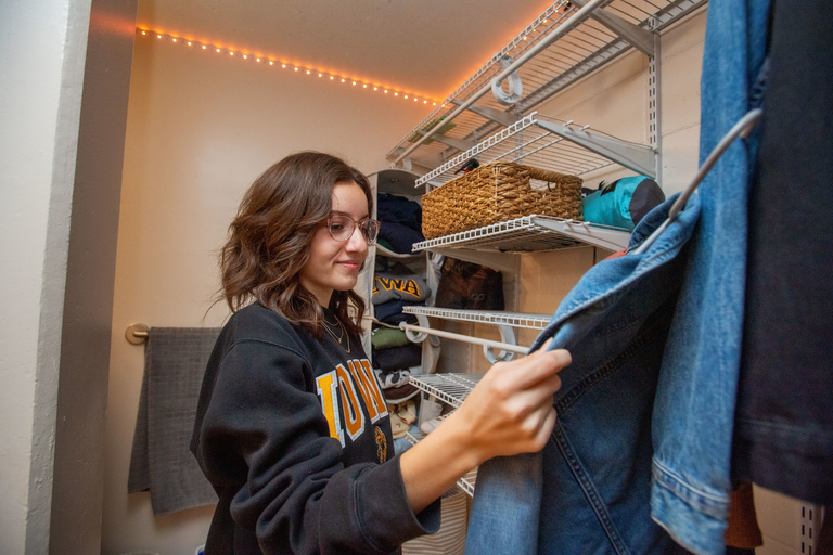 Student picking items from a closet