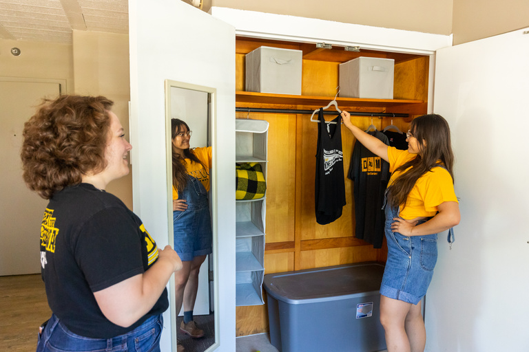 Student grabbing items from a closet 
