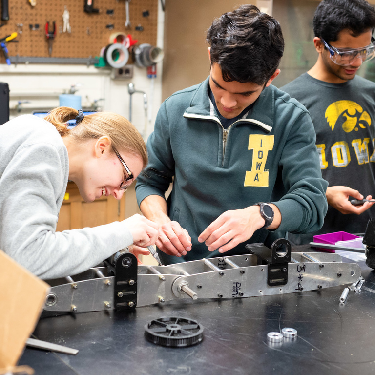 Engineering students building a model in a class
