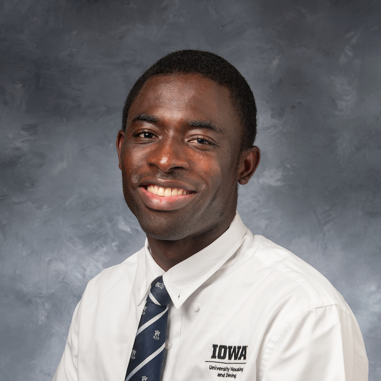 headshot of Kwaku Abinaba, man wearing white collared shirt and a tie
