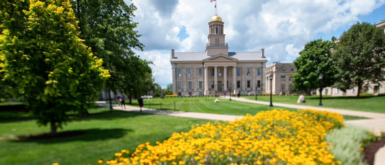 Old Capitol with building with yellow flowers in front