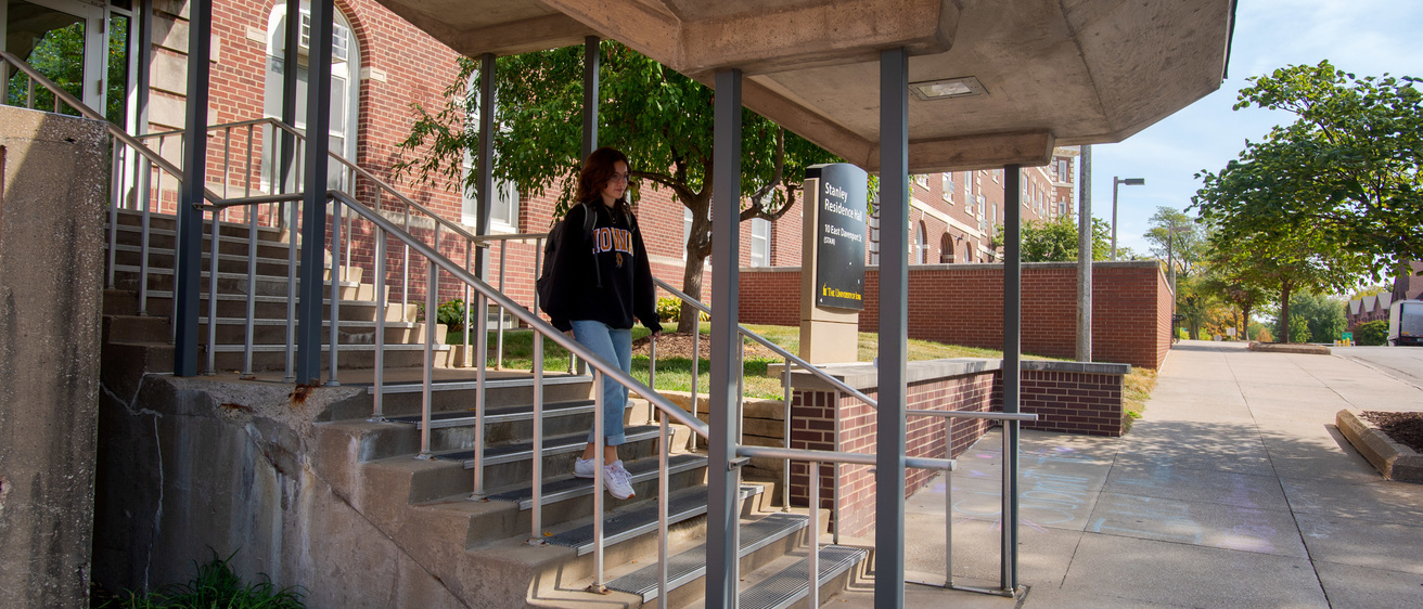 Student walking down a flight of stairs