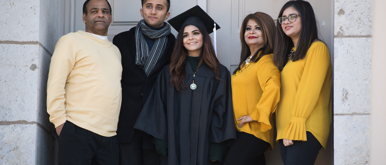 photo of Hawkeye graduate with four family members in front of the Old Capitol Museum