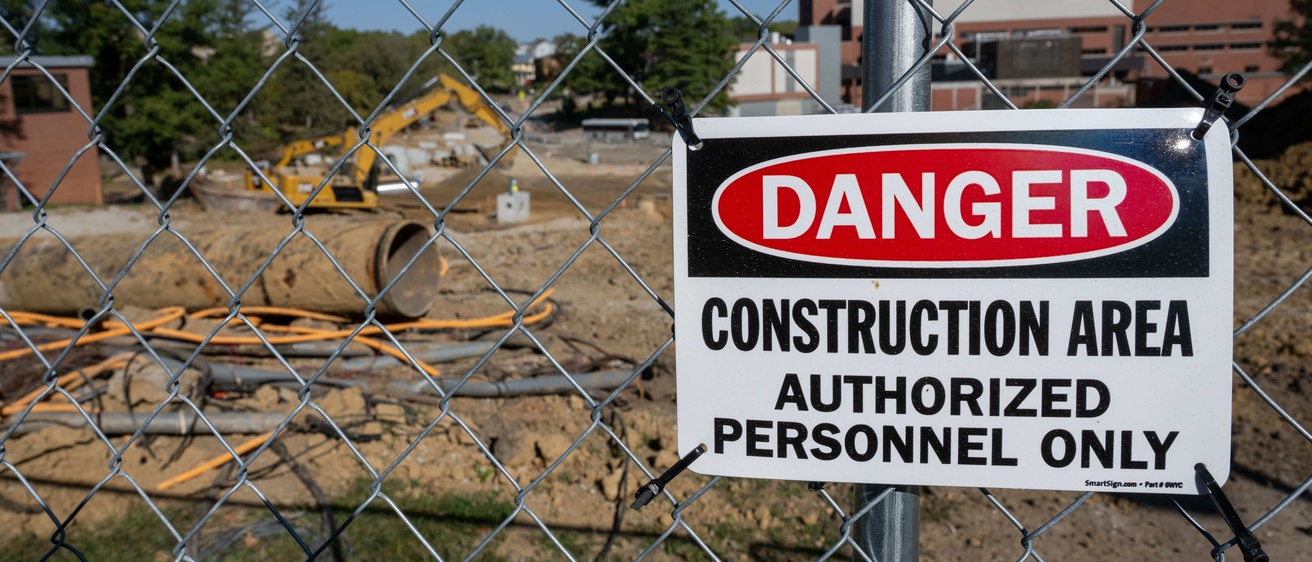 A "danger construction area" sign is posted outside a site on the University of Iowa campus
