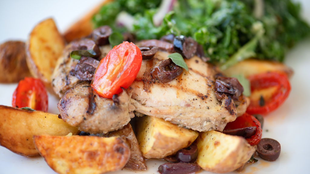 Grilled chicken, kale, tomatoes, and potato wedges